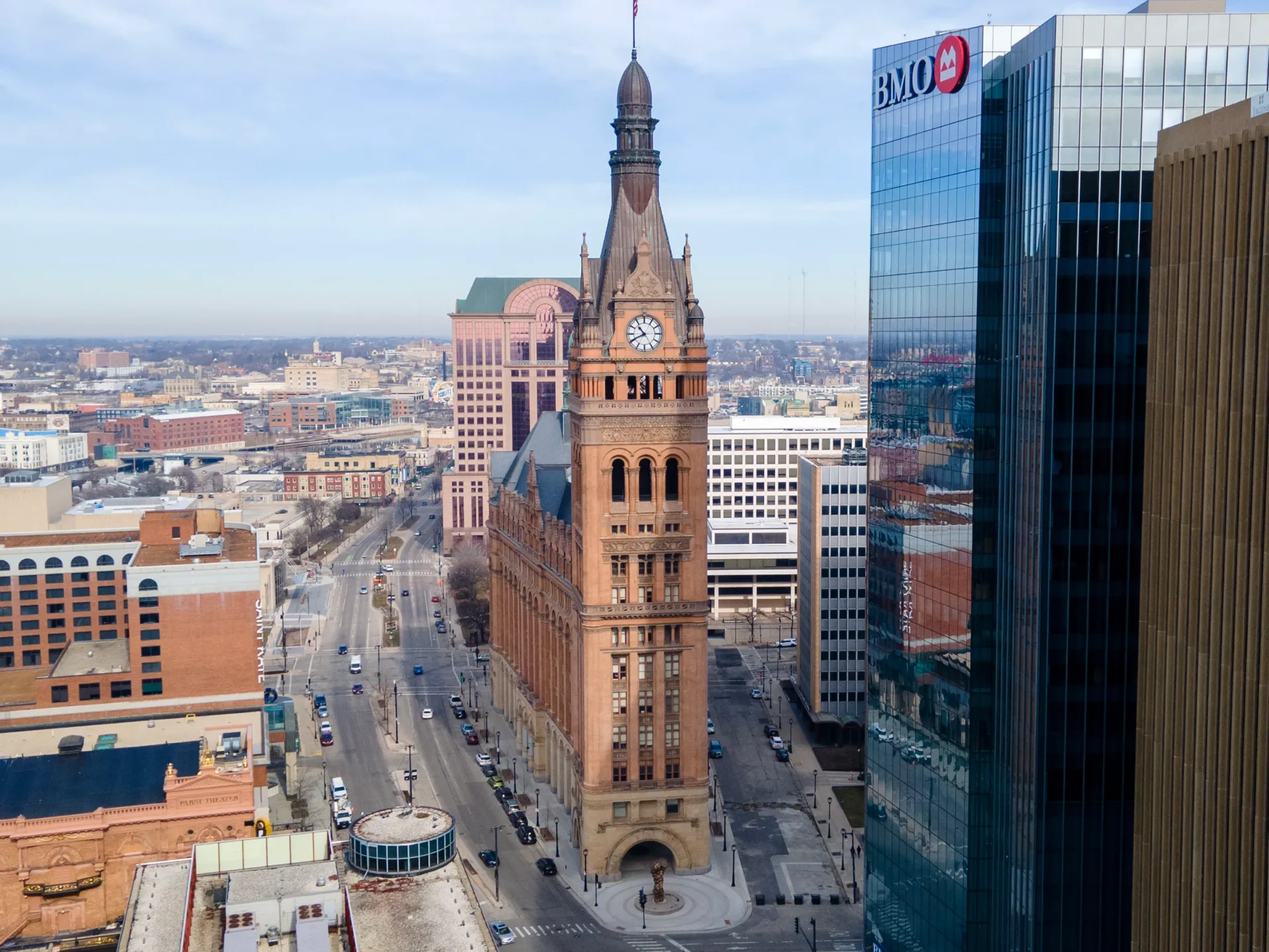 A large clock tower in the middle of a city.